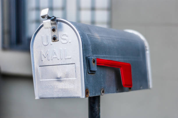 istock Metal US Mail style mailbox on fence outside a home 1273007040