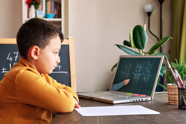 istock 6-7 years cute child learning mathematics from computer. Learning at home. 1273007053