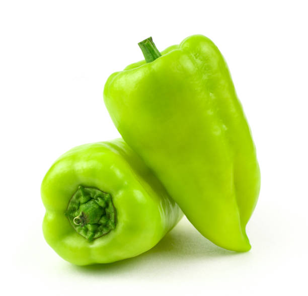 dois pimentões verdes em um fundo branco com espaço para copiar. - pepper bell pepper growth ripe - fotografias e filmes do acervo