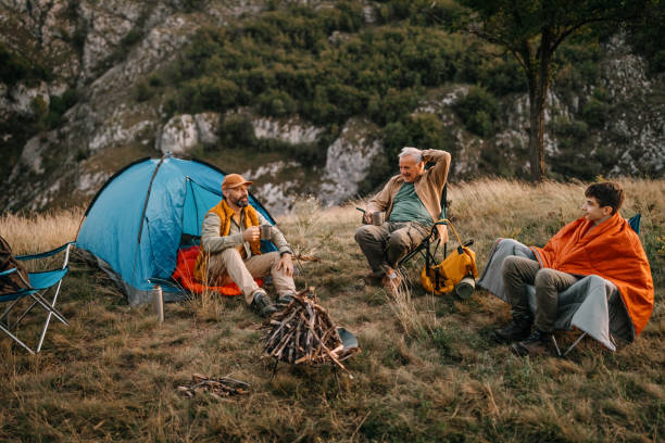 three generations males enjoying camping adventure - camping tent offspring 60s imagens e fotografias de stock