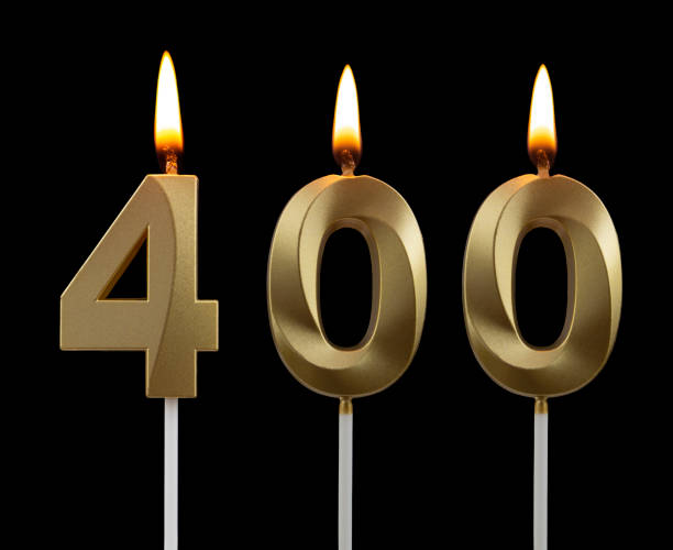 istock Birthday golden candle on black background, number 400 1273010516