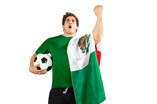 Young sad man with a soccer ball and a mexican flag after Shouting of emotion.