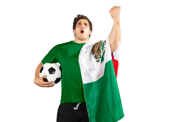 Young man with a soccer ball and a mexican flag after Shouting of emotion. stock photo