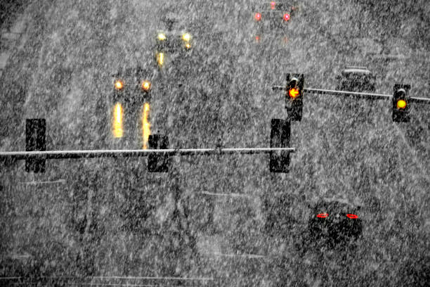 driving on snow and snowy roads in winter traffic lights blizzard - drifted imagens e fotografias de stock