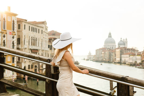 istock Girl in a hat walks at dawn in venice 1273015733