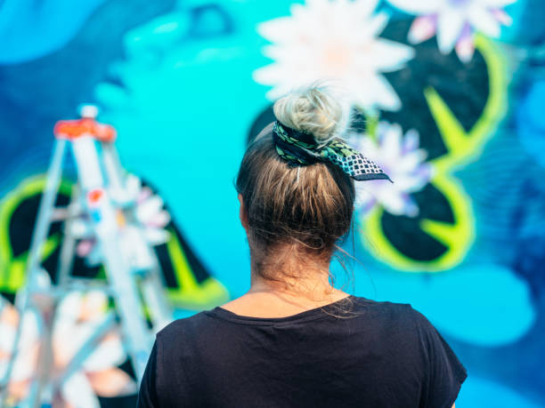 istock Female mural artist at work 1273015758