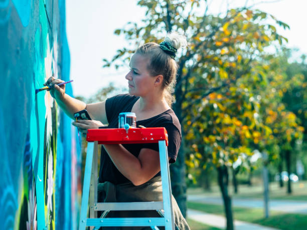 istock Female mural artist at work 1273015785