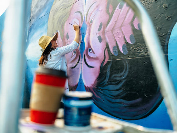 istock Female mural artist at work 1273015794