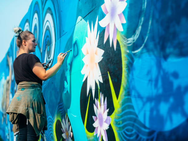 istock Female mural artist at work 1273015827