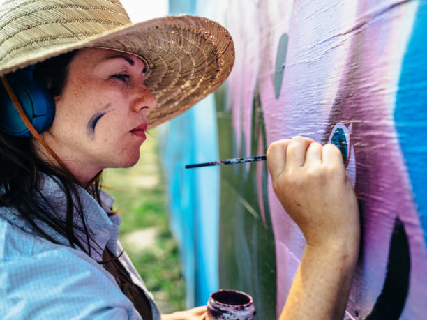 istock Female mural artist at work 1273015856