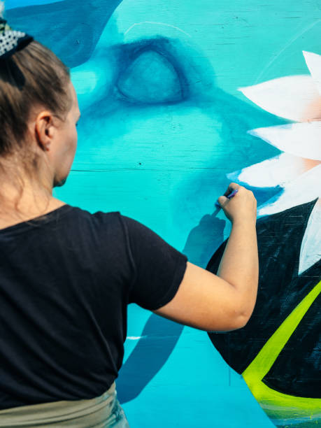 istock Female mural artist at work 1273015909