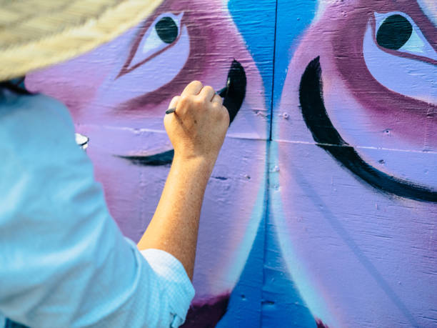 istock Hand of Female mural artist at work 1273016122