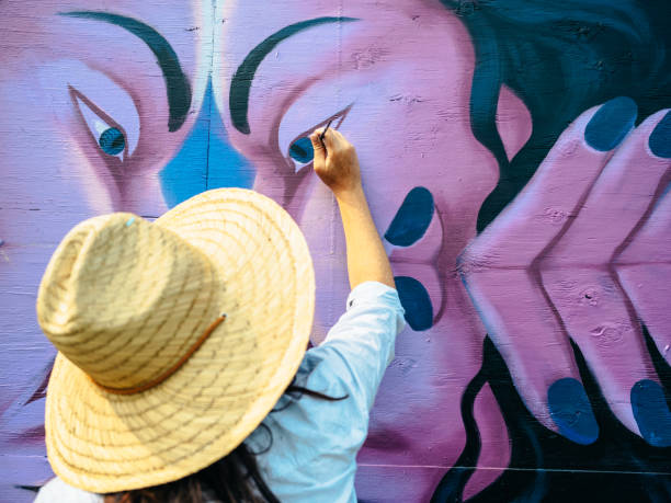 istock Female mural artist at work 1273016831