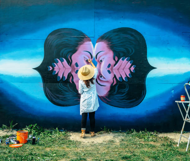 istock Female mural artist at work 1273016852