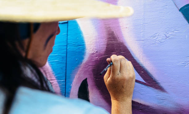 istock Female mural artist at work 1273016855