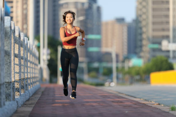 istock woman jogging on city bridge 1273017088