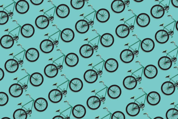 Bicycles pattern Bicycles seamless pattern on green background bicycle backgrounds stock illustrations