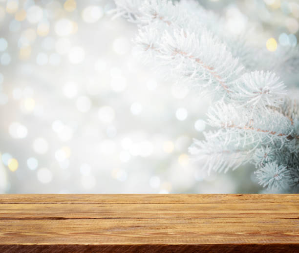 istock Christmas tree branches with wooden background 1273017915