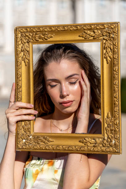istock Advertising model posing with gold frame like an oil painting 1273018466