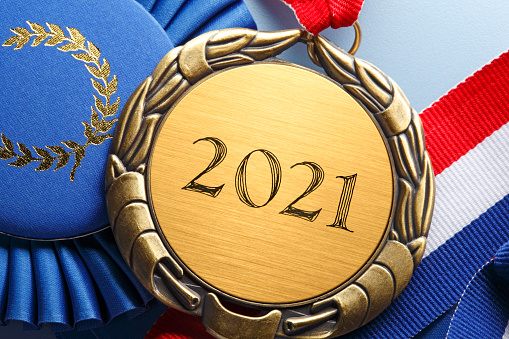 A close up of a gold medal engraved with the year, \