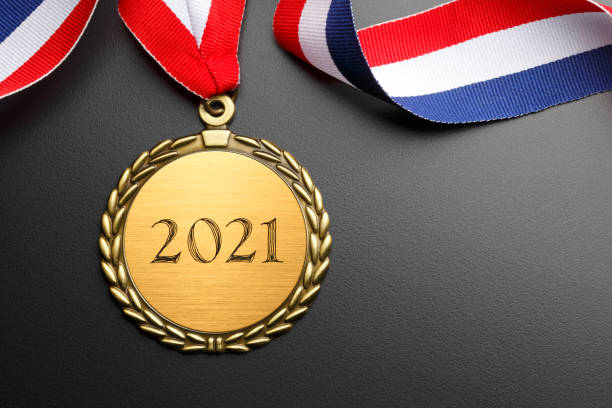 istock Gold Medal Inscribed With 2021 On Dark Gray Background 1273029525
