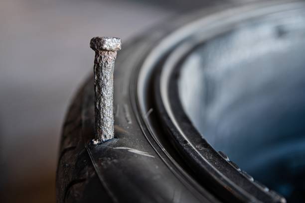 istock Broken tire. Flat broken tire destroyed by a screw. 1273031485
