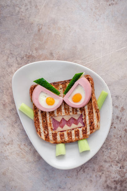 istock Monster sandwich with sausage, eggs and cheese on plate. 1273032815