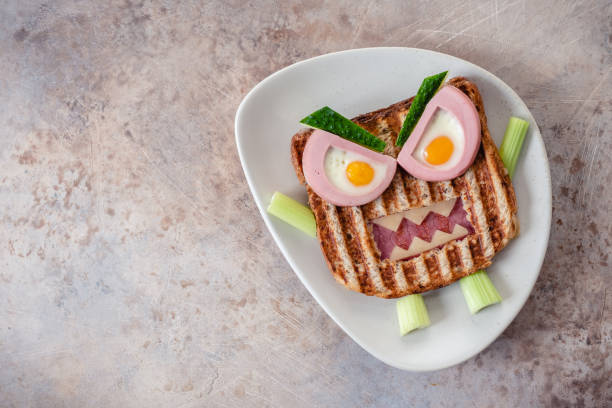 istock Monster sandwich with sausage, eggs and cheese on plate. 1273033003