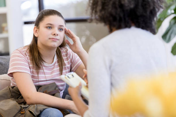 Teen girl upset when confronted by unrecognizable counselor The teen girl gets upset when the unrecognizable female counselor confronts her during a counseling session. uncomfortable stock pictures, royalty-free photos & images