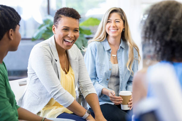 istock Mid adult mom laughs in group therapy 1273041072