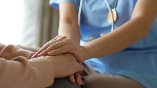 Take care Moment,Female doctor holding hand of senior grandmother patient