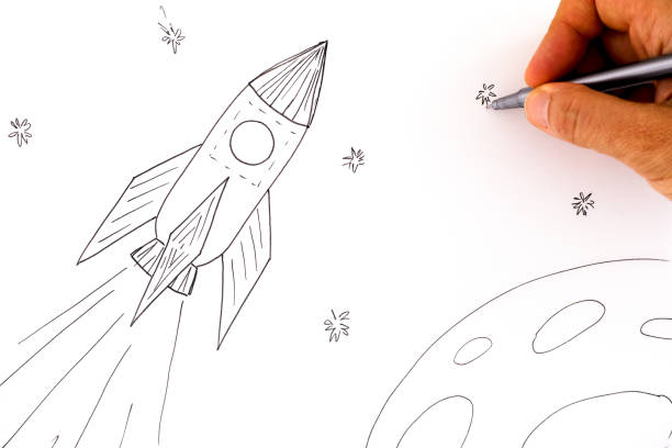istock Woman hand with pen drawing picture with Rocket in space. 1273051688