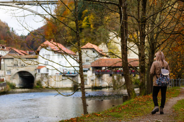 istock Redhead girl with suitcase in the autumn park. 1273077310