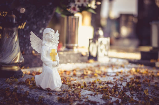 beautiful cute innocent white angel - angel praying statue human knee imagens e fotografias de stock