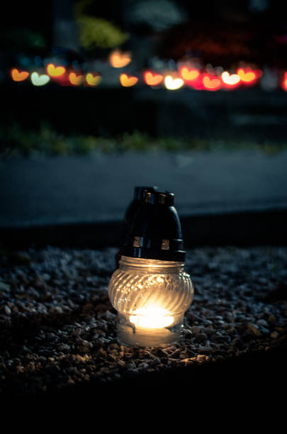 istock white lantern shining at night during All Saints Day in the cemetery 1273093111