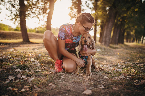 istock One woman cuddling with her cocker spaniel dog in nature 1273100305