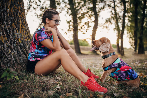 istock Beautiful young woman sitting in nature her cocker spaniel dog 1273103162