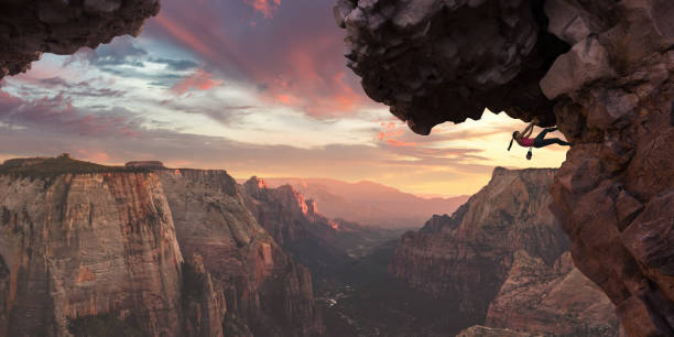 female extreme climber near high altitude overhang on dawn climb - rock climbing fotos imagens e fotografias de stock