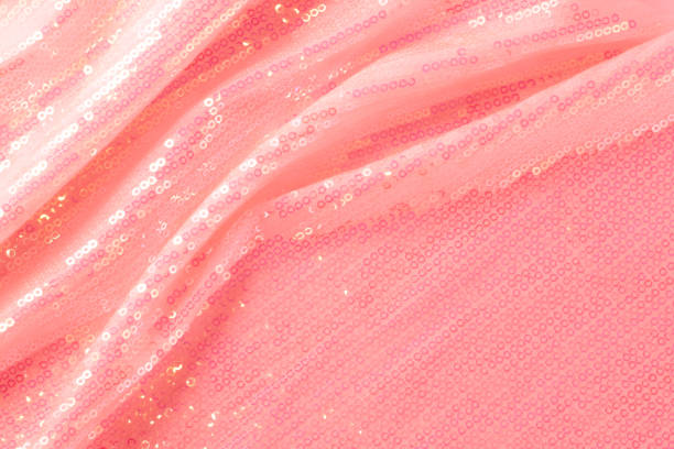 Large shiny glossy pink sequins background. Photography on the theme of the trend color 2019. Large shiny glossy orange sequins fully filling the background space. red tiger lily stock pictures, royalty-free photos & images
