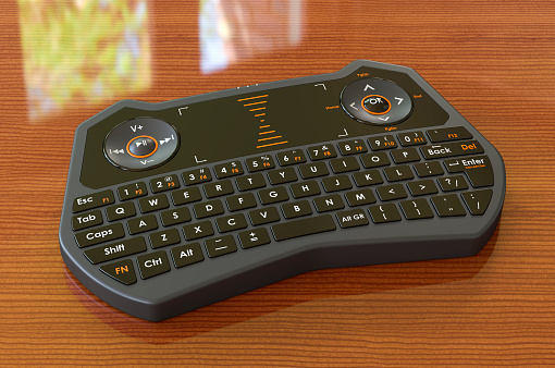 Mini Wireless Bluetooth Keyboard on the wooden table, 3D rendering