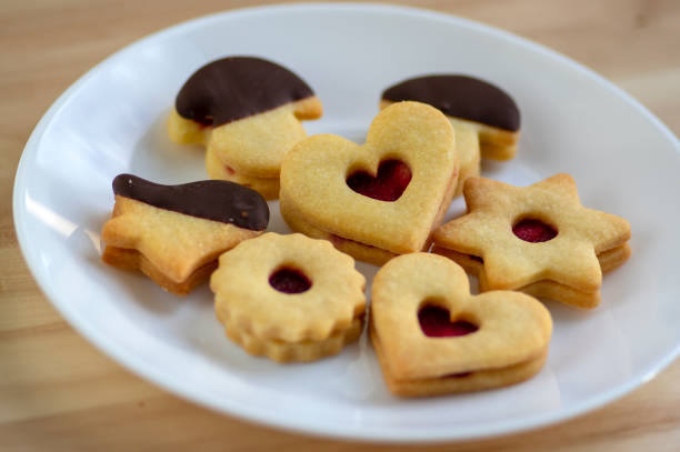 istock Christmas linzer sweets and cookies made from shortcrust pastry, various shapes filled with marmalade, decorated with chocolate 1273138613