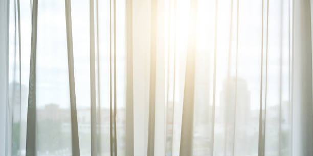 istock sunlight shines through transparent curtains into room 1273155454