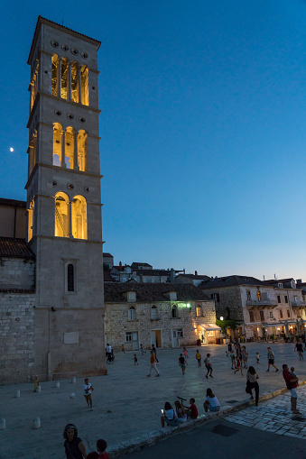 Hvar, Croatia - July 28, 2020: Tourists on the Main Square in front of the Roman Catholic cathedral of St. Stephen at night
