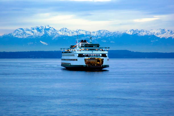 The Seattle-Bremerton Ferry at Dusk The Seattle-Bremerton ferry at dusk and set against the Olympic Mountains at dusk on December 30, 2006. ferry stock pictures, royalty-free photos & images