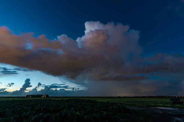 Thunderstorm over the dutch countryside during blue hour. Some clouds are blurred because of their motion during the long exposure time.