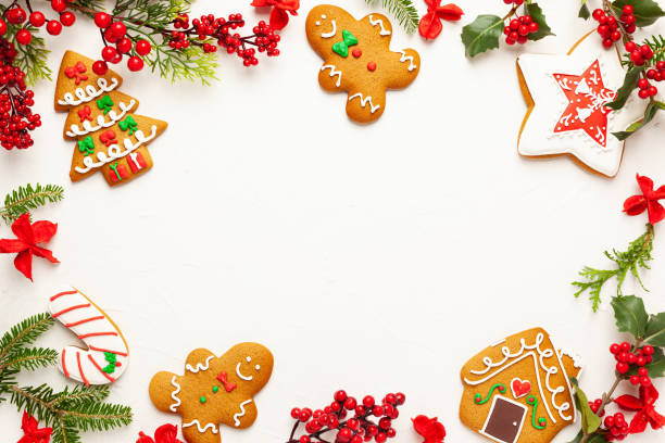 istock Christmas background with gingerbread cookies, gift boxes and branches of holly 1273169664