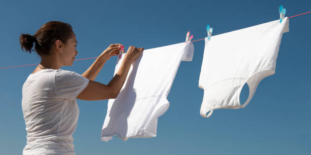 istock Woman Hanging White Clothes 1273170012