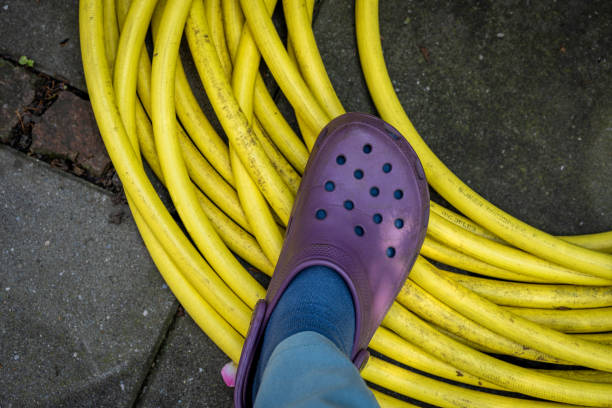 Shoe is standing on the hose, it's a german idiom who makes no sense in english. stock photo