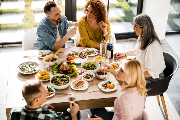 istock Happy friends spending time together during festive dinner 1273172783