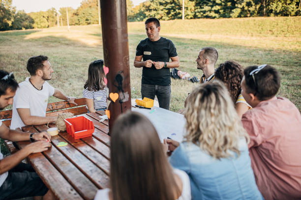 istock Creative and young people on a team building meeting outdoors 1273192941
